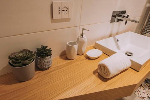a bathroom with a sink and a towel on a counter at Sea Glow Luxury Apartment 2BR 2BA con vista mare a Bisceglie in Bisceglie