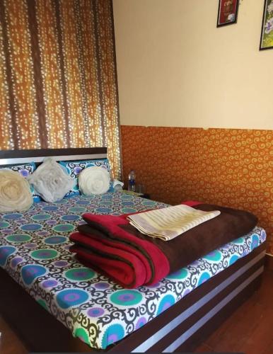 a bed with blankets and towels on top of it at Joshi Holiday Home Stay in Lansdowne