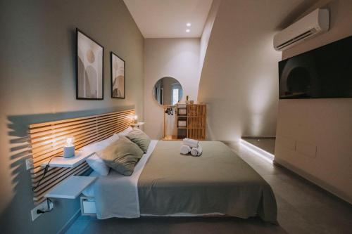 a bedroom with a large bed with a large headboard at Sea Glow Luxury Apartment 2BR 2BA con vista mare a Bisceglie in Bisceglie