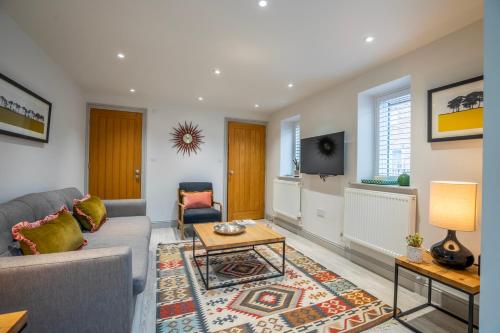 a living room with a couch and a table at The Smithy in York