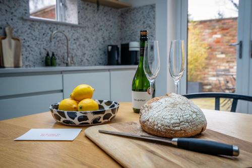 a table with a bottle of wine and a bowl of lemons at The Smithy in York