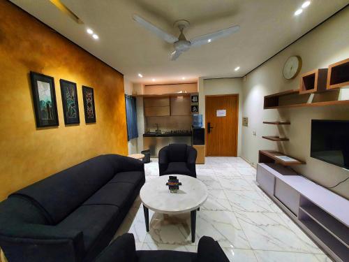 a living room with a couch and a table at Danny Luxe Apartments in Islamabad