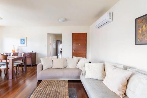 a living room with a couch and a table at Warm Residence in the heart of the City Center - Balcony & view in Nicosia