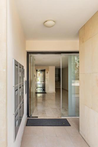 an empty hallway with a glass door in a building at Warm Residence in the heart of the City Center - Balcony & view in Nicosia