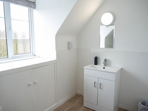 a white bathroom with a sink and a mirror at Horton Inn in Horton