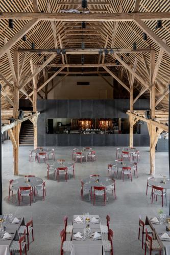 a large room with tables and chairs in it at Broløkke Herregård in Humble