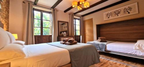 a bedroom with two beds and a teddy bear on the bed at DS Casa San Fernando in Córdoba