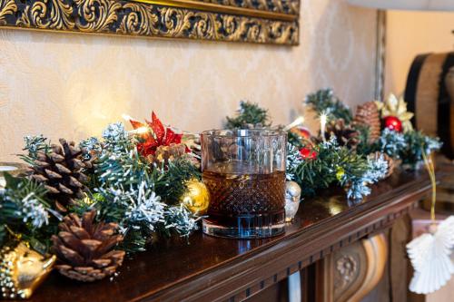 a cup of tea on a table with christmas decorations at Kingston House in Torquay