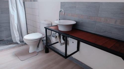 a bathroom with a toilet and a sink at Hilton Bed & Breakfast in Maun