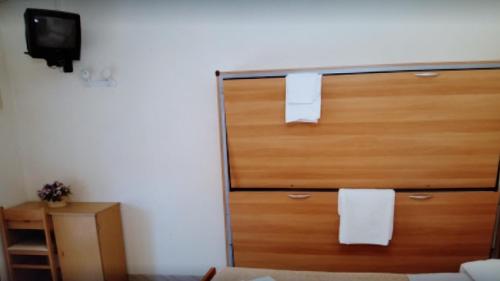 a bedroom with a wooden dresser with towels on it at Hotel AnnaMare in Rimini