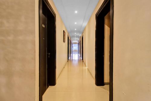 an empty corridor in a building with a long hallway at SPOT ON Anay Inn in Nagpur