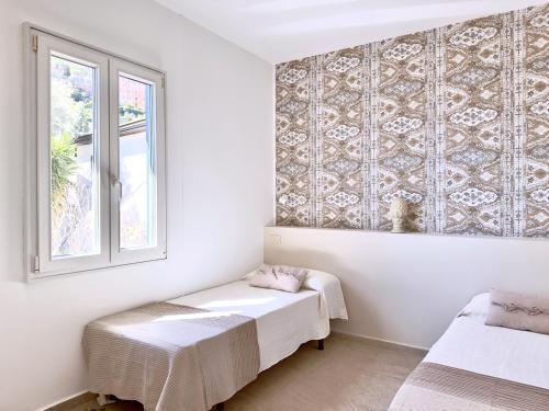 a room with two beds and a window at Residence Terra Rossa Taormina in Taormina
