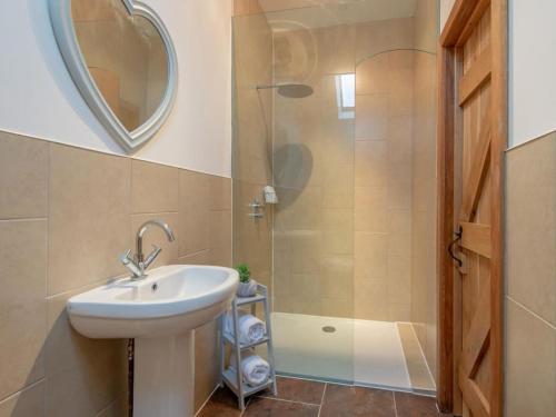 a bathroom with a sink and a shower at Nook Cottage, Hot Tub, Polar Bears, Alton Towers, Bakewell, Chatsworth House, Peak District Stay in Foxt