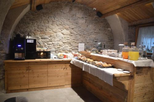 a kitchen with a table with food on it at Le Suites de San Campel RTA in Ponte di Legno