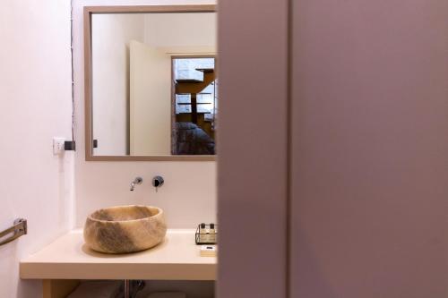 a bathroom with a sink and a mirror at Le Nicchie luxury rooms in Lecce