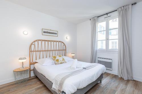 une chambre blanche avec un grand lit et une fenêtre dans l'établissement 2 Bdrs & Parking in the Old Town !, à Nice