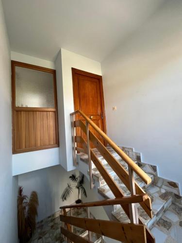 a staircase in a house with a wooden door at Casa Vazan in Laguna Dalga