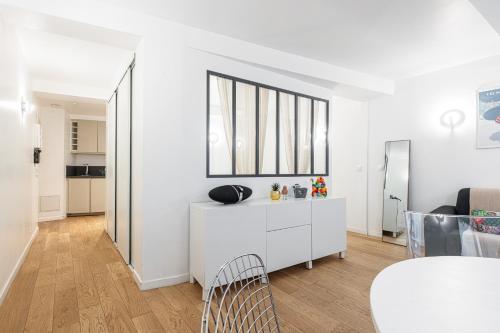 un salon blanc avec une armoire blanche et une table dans l'établissement Quiet and cosy 1bdr in Vieux Nice!, à Nice