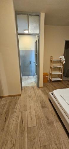 an empty room with a bed and a sliding glass door at Flat City Center Mindelo in Mindelo