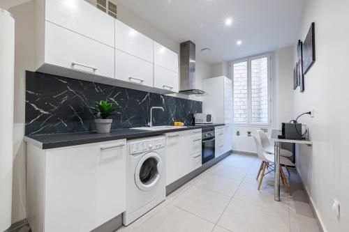 a white kitchen with a washing machine and a sink at Charming 1 Bdr Old town in Nice