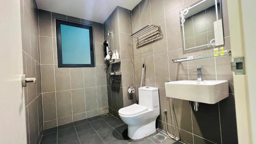 a bathroom with a toilet and a sink and a window at Sunway lagoon Greenfield 3R2B w/tvbox in Petaling Jaya