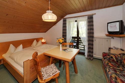 a bedroom with a bed and a table and a couch at Haus Jupp in Zandt