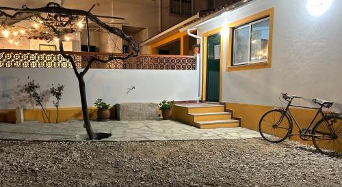 a bike parked outside of a house with a building at Quinta dos Avós in Juncal