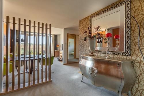 a bathroom with a tub and a mirror at Hotel Santa Margarida in Oleiros
