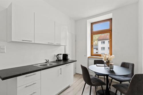 a kitchen and dining room with a table and a window at FarawayHomes Studio Sankt Michael #5 in Liesingthal
