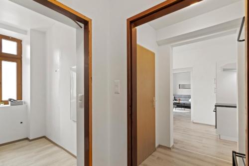 an open door into a living room with white walls at FarawayHomes Studio Sankt Michael #5 in Liesingthal