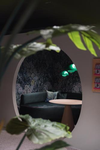 a living room with a couch and a table in a mirror at Bunks at Rode in Oslo