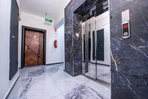 a elevator lobby with a black marble wall at SEYİREVLERİ SUİT ŞUBESİ in Melikgazi