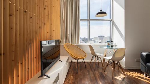 a room with a table and chairs and a window at Boavista 1774 by LovelyStay in Porto
