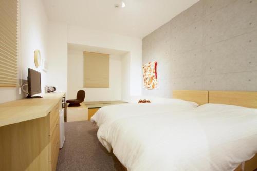 a bedroom with a large white bed and a desk at Sweet Stay Kyoto - Vacation STAY 13383v in Kyoto