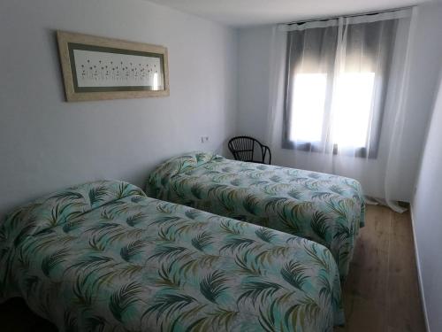 a living room with two chairs and a couch at Hostal Sa Malica in Blanes