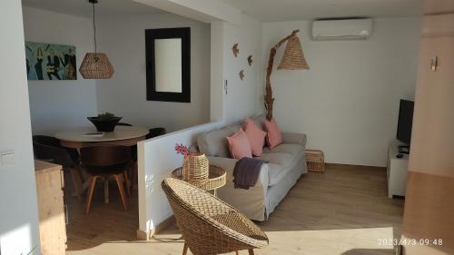 a living room with a couch and a table at Hostal Sa Malica in Blanes
