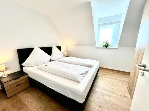 Ένα ή περισσότερα κρεβάτια σε δωμάτιο στο Braviscasa Stadthaus Kaiserstuhl Endingen