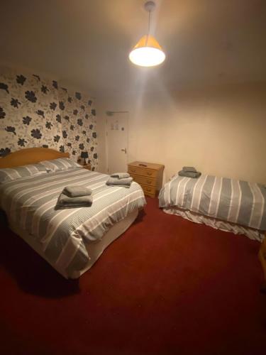 a bedroom with two beds with towels on them at The Bowmans in Howden