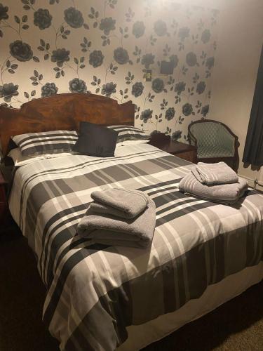 a bedroom with a bed with towels on it at The Bowmans in Howden