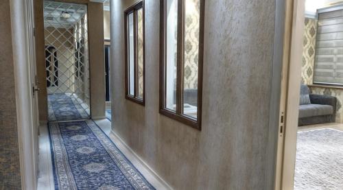 a hallway of a home with a door and a mirror at Home hearth - Домашний очаг in Dushanbe