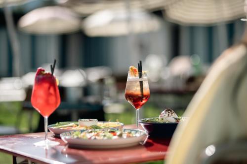 a table with plates of food and two glasses of wine at Gstaad Palace in Gstaad