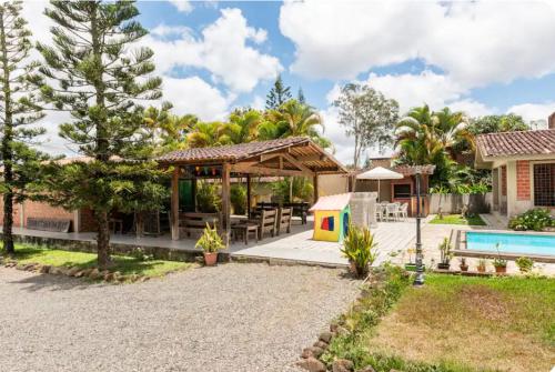 a house with a swimming pool and a backyard at Casa Santa Felicidade - Gravatá in Gravatá