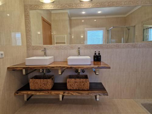 a bathroom with two sinks and a mirror at Villa Domino Ibiza in Sant Francesc de s'Estany