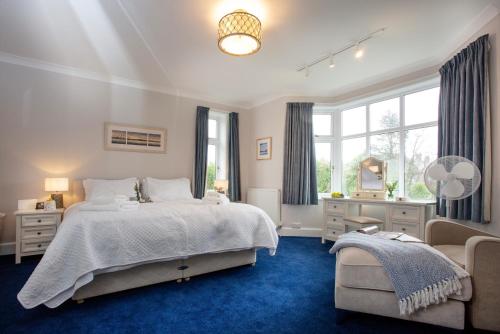 a bedroom with a large bed and a window at Toller House in Exmouth