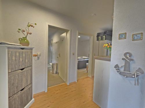 a living room with a hallway with a sink and a room at Ferienwohnung Bernhard EG in Norden