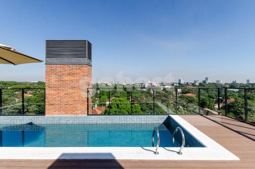 a swimming pool on the roof of a building at Distinguished And Elegant Apartment 2 Bedroom in Asuncion