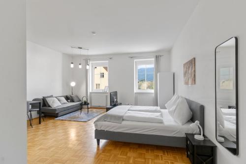 a bedroom with a bed and a living room at StayEasy Apartments Krieglach W1 