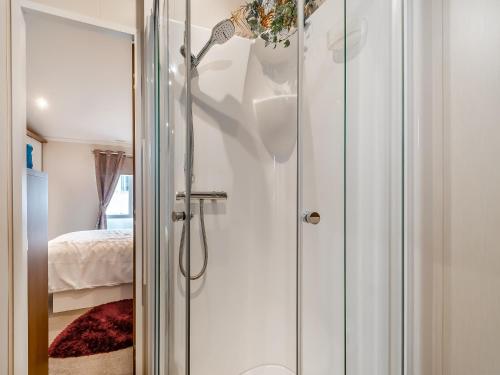 a bathroom with a shower with a glass door at Sea View Lodge in Horden