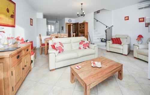 a living room with a couch and a table at Amazing Home In Aigues-Mortes With Wifi in Le Grau-du-Roi