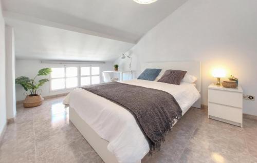 a white bedroom with a large bed and a window at Cozy Apartment In Castell De La Plana With Wifi in Castellón de la Plana